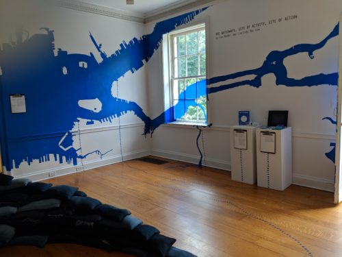This installation maps waterways in blue paint on a room's white walls to envision connection and community across New York City.